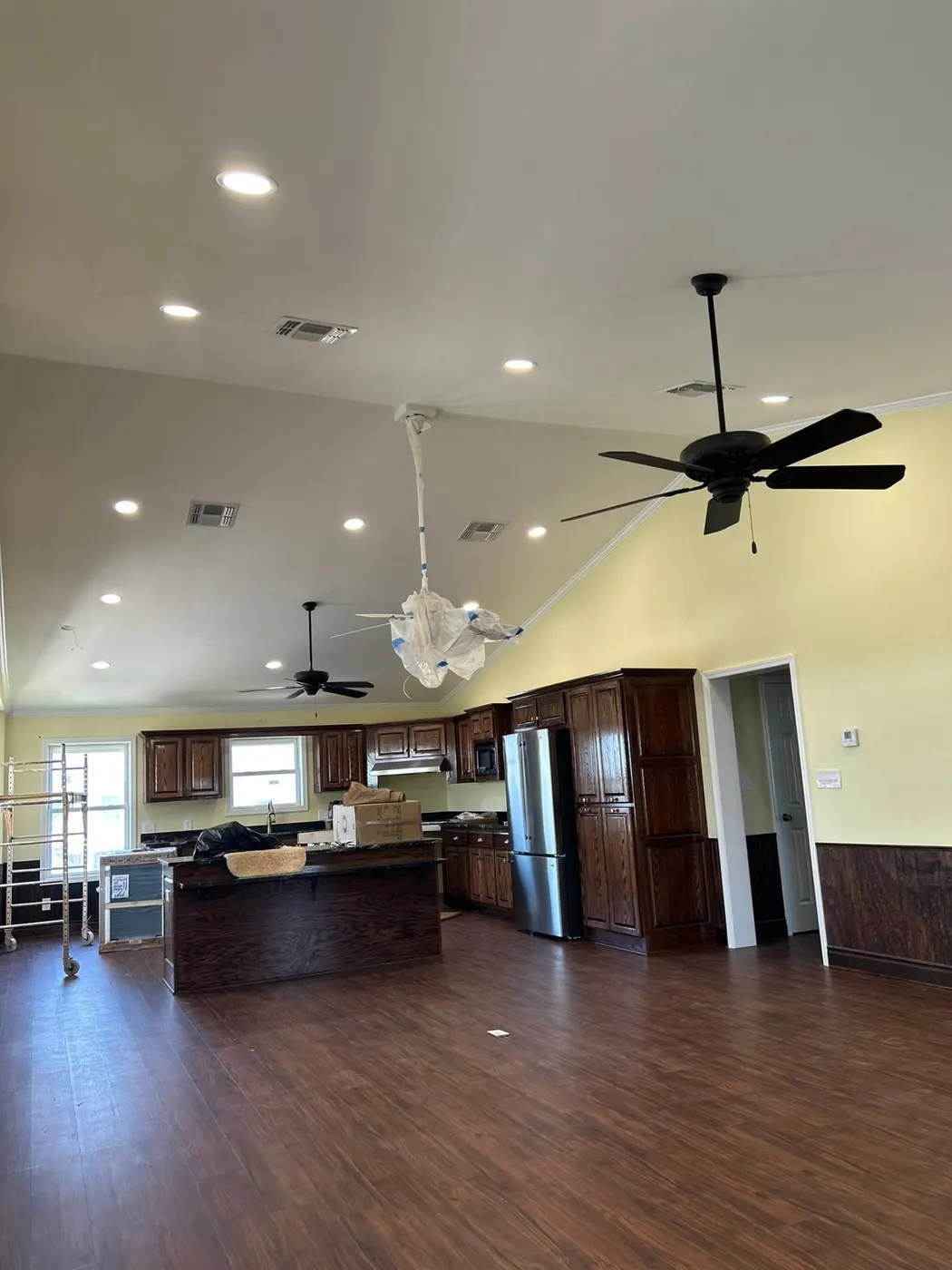 Finished open kitchen with recessed lighting and ceiling fans